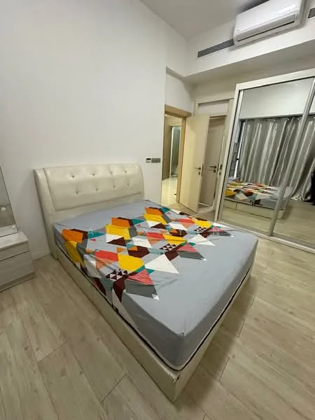 Bedroom features: king-size bed, upholstered headboard, colorful geometric bedspread, wooden flooring, built-in wardrobe with sliding mirror doors, floor-to-ceiling window with sheer curtains, wall-mounted split AC, decorative wall with light color, nightstand, framed mirror; style: modern.