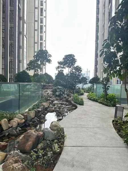 Exterior type: high-rise condominium; features: landscaped garden, walking path, water feature with rocks, glass railing, mature trees, tropical landscaping, manicured shrubs, paved walkway; style: modern.