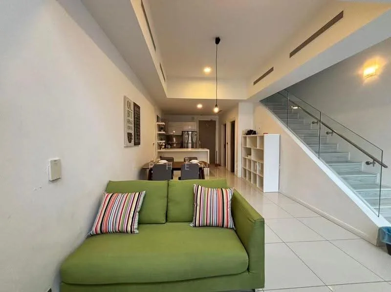 Living features: green fabric sofa with striped cushions, white painted walls, tile flooring, recessed downlights, open-plan layout to kitchen, glass railing staircase, dining table with chairs visible in background, kitchen appliances visible in background; style: modern.