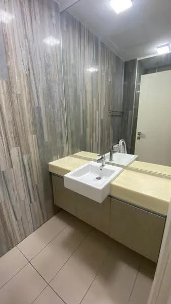 Bathroom features: single-sink vanity with beige countertop, white rectangular sink, chrome basin mixer faucet, grey and beige tiled walls, beige tile flooring, mirror above sink, built-in cabinetry below sink, recessed ceiling lights; style: modern.