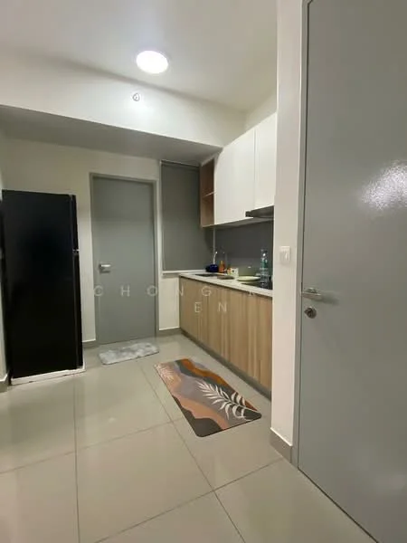 Kitchen features: black refrigerator, grey cabinet doors, wooden lower cabinets, white upper cabinets, stainless-steel sink, chrome faucet, countertop with backsplash, tile flooring, recessed ceiling light, kitchen mat; style: modern.