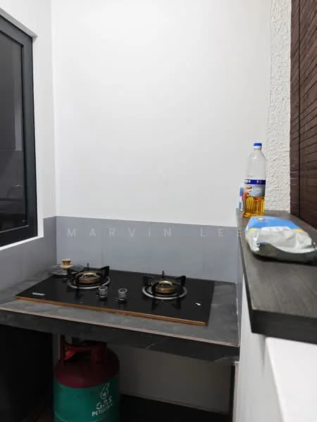 Kitchen features: black countertop, two-burner gas hob, gas cylinder, grey tiled backsplash, white painted walls, window with black frame, bottle of cooking oil, packaged food item; style: modern.