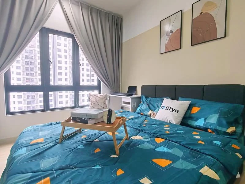 Bedroom features: king-size bed with teal bedding, upholstered headboard in dark green, two framed artworks on the wall, floor-to-ceiling windows, grey curtains, wooden bedside table, decorative pillow with logo, study desk with chair, light-colored flooring, wall-mounted light fixture; style: modern; view: city.