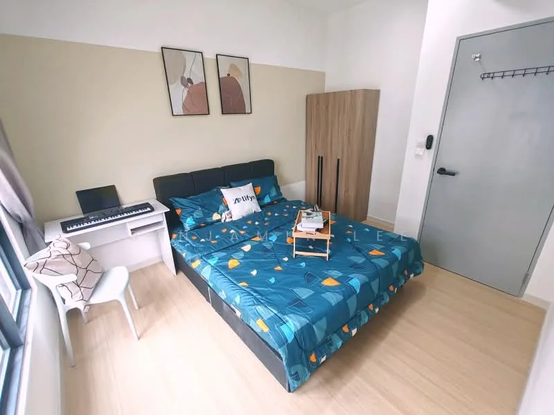 Bedroom features: queen-size bed with patterned bedding, wooden wardrobe, white desk with keyboard, white chair, laminate flooring, painted walls in light beige and white, window with sheer curtains, wall-mounted coat rack, decorative artwork on walls, bedside table with lamp; style: modern.