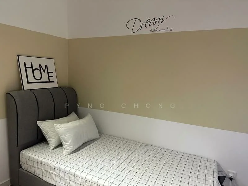Bedroom features: single bed with grey upholstered headboard, white bedding with decorative pillows, framed artwork with 'HOME' text, wall with two-tone paint (cream and beige), decorative wall text 'Dream... if you can do it', checkered pattern bed sheet, white walls, wooden flooring; style: modern.