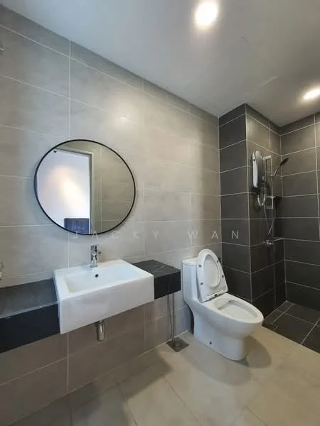 Bathroom features: square white sink, chrome faucet, round mirror, wall-mounted toilet, shower area with glass partition, rain shower head, handheld shower, grey tiled walls, black tiled accent wall, light beige floor tiles, recessed lighting; style: modern.