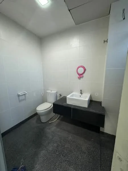 Bathroom features: white tiled walls, black stone countertop, square white sink, chrome faucet, one-piece toilet, mirror with pink frame, grey flooring, ceiling light; style: modern.