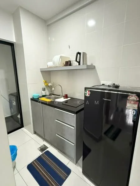 Kitchen features: grey cabinetry, single-bowl stainless-steel sink, chrome pull-down faucet, black fridge, white countertop, wall-mounted shelf, kettle, dish rack, blue mat, tile backsplash, white tiled walls, white tiled flooring; style: modern.