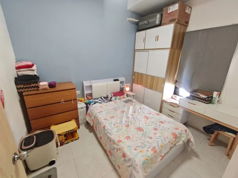Bedroom features: queen-size bed with floral bedding, wooden dresser in brown, white bedside table, built-in wardrobe with wood and white finish, study desk with chair, window with grey curtain, tile flooring, wall-mounted air conditioning unit.