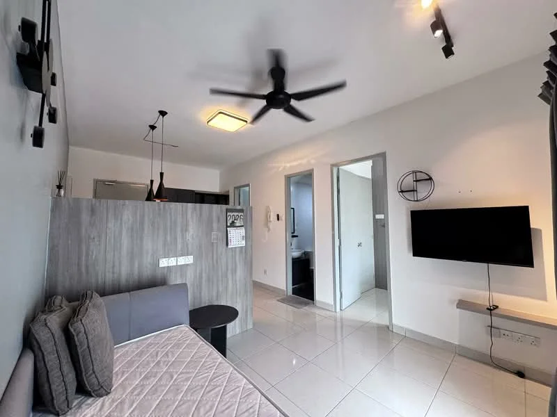Living features: grey fabric sofa, wall-mounted TV, 5-blade ceiling fan with light, recessed downlights, white painted walls, glossy tile flooring, open layout to kitchen, decorative wall art, sliding door to hallway; style: modern. Kitchen features: stainless-steel fridge, kitchen cabinetry, countertop with backsplash, open layout to living area; style: modern. Bathroom features: white tiled walls, grey tiled flooring, shower area, toilet, sink with mirror; style: modern.