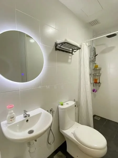 Bathroom features: white tiled walls, black tile flooring, round mirror with LED backlight, single-sink vanity with chrome faucet, one-piece toilet, shower with handheld showerhead, shower curtain, wall-mounted storage rack, shower caddy with toiletries; style: modern.