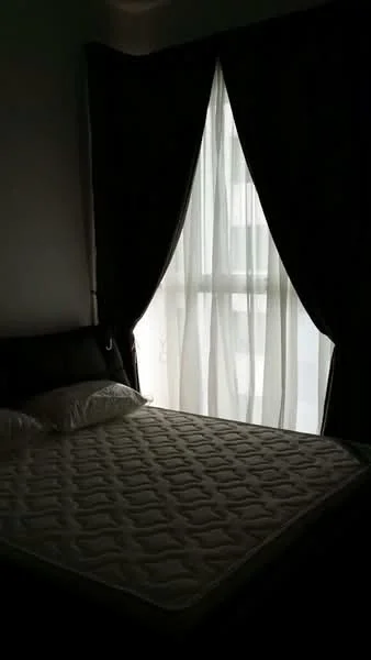 Bedroom features: queen-size bed, black leather headboard, white bedding, floor-to-ceiling window, sheer curtains, dark curtains, wall-mounted light fixture, neutral wall color; style: modern.