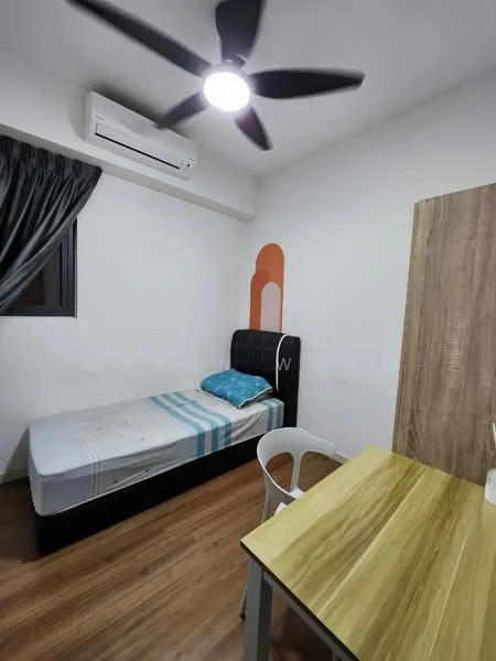 Bedroom features: single bed, blue bedding, wooden flooring, wall-mounted air conditioning unit, 5-blade ceiling fan with light, black upholstered headboard, wooden study table, white plastic chair, curtains, accent wall with orange design; style: modern.