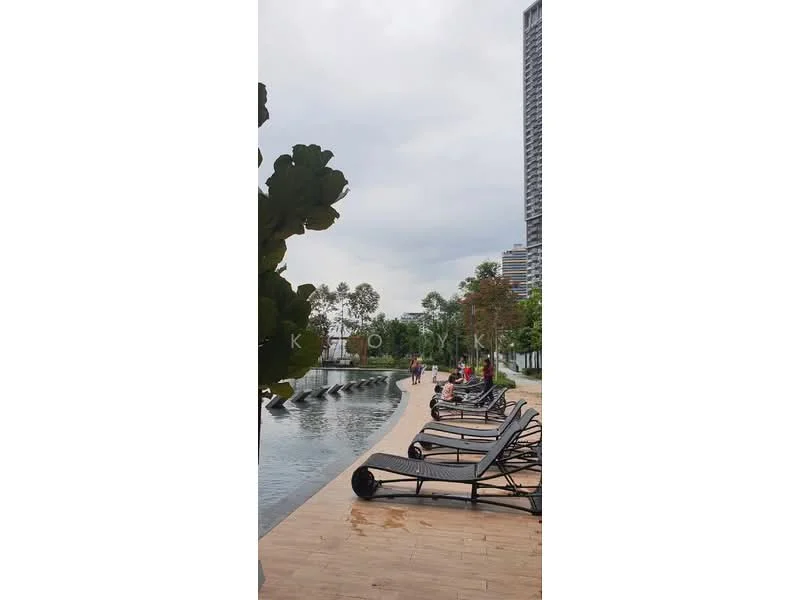 Exterior type: swimming pool deck; features: infinity pool, pool deck with loungers, landscaped greenery, paved walkway, surrounded by trees, high-rise buildings in background; style: modern.