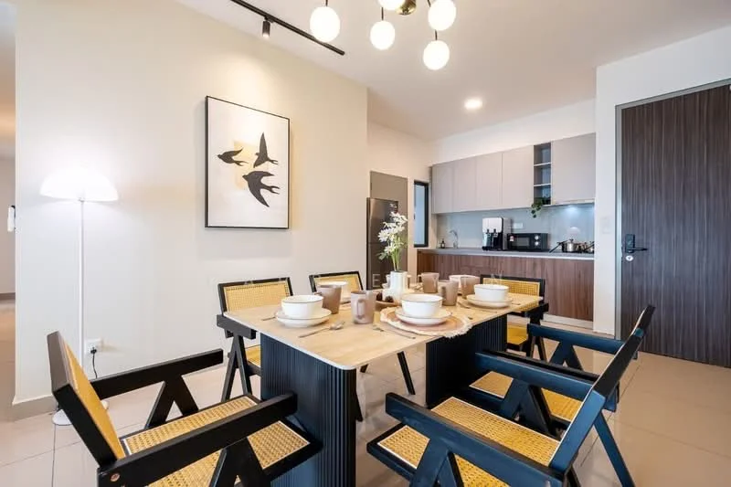 Dining features: dining table with natural wood finish, 6 dining chairs with black frames and woven seats, decorative table setting with plates and cups, floor lamp with white shade, framed artwork on wall with abstract design, light fixture with multiple bulbs, open kitchen area in background, grey cabinetry with wood accents, stainless-steel fridge visible, neutral wall color, tile flooring; style: modern. Kitchen features: grey cabinetry, wooden cabinet doors, black countertop, built-in appliances, stainless-steel fridge, open shelving, kitchen utensils visible; style: modern.