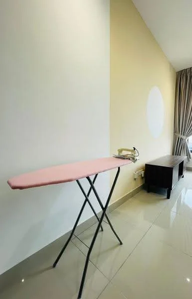 Room features: pink ironing board, white walls, glossy tile flooring, brown wooden cabinet, floor-to-ceiling window with curtains.