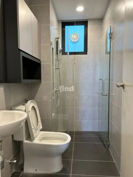 Bathroom features: white ceramic toilet, glass shower enclosure, rain shower head, chrome wall-mounted faucet, single-sink vanity with cabinet, grey tiled walls, dark grey tiled flooring, window for natural light, mirror above sink; style: modern.