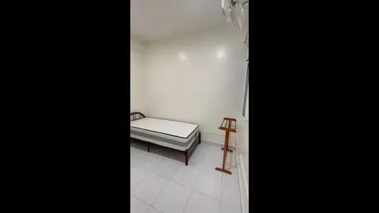 Bedroom features: white painted walls, tile flooring, single bed frame, mattress, wooden bedside table, ceiling fan.