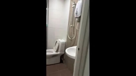 Bathroom features: one-piece toilet, built-in bathtub, shower with handheld showerhead, white tiled walls, light beige tiled flooring, water heater, glass shower screen; style: modern.