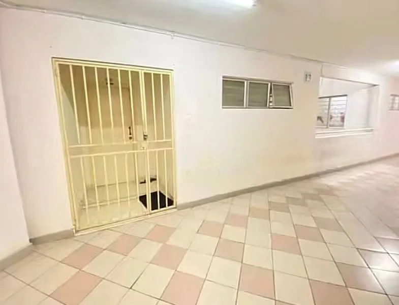 Room features: white painted walls, tile flooring with pink and cream pattern, security grille door, small window, large window, fluorescent ceiling light.