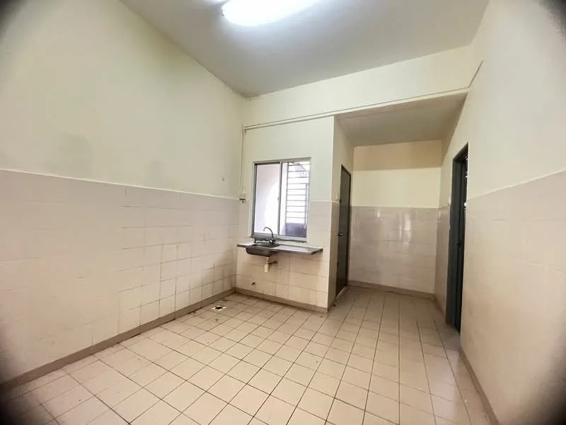 Kitchen features: white painted walls, cream tiled walls, light grey floor tiles, single-bowl stainless-steel sink, window with metal grille, door to adjacent room, wall-mounted light fixture, no visible appliances.