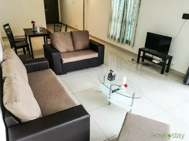 Living features: 3-seater fabric sofa in beige, 2-seater leather sofa in dark brown, glass coffee table, TV console, wall-mounted TV, tile flooring, white painted walls, curtains with floral pattern, dining table for 4, black dining chairs, decorative items on table; style: modern.