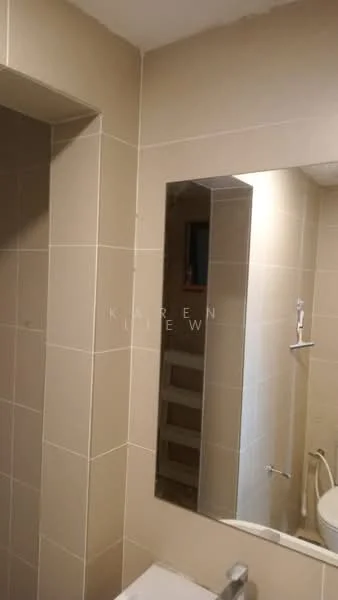 Bathroom features: beige tiled walls, mirror with rectangular shape, shower head, toilet, white sink, chrome faucet, towel rack, light fixture.