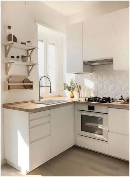 Kitchen features: white cabinetry, wood countertop, single-bowl stainless-steel sink, chrome pull-down faucet, gas stove with 4 burners, built-in oven, white hexagonal tile backsplash, open shelving, natural light from window, decorative plants, minimalist design; style: modern.