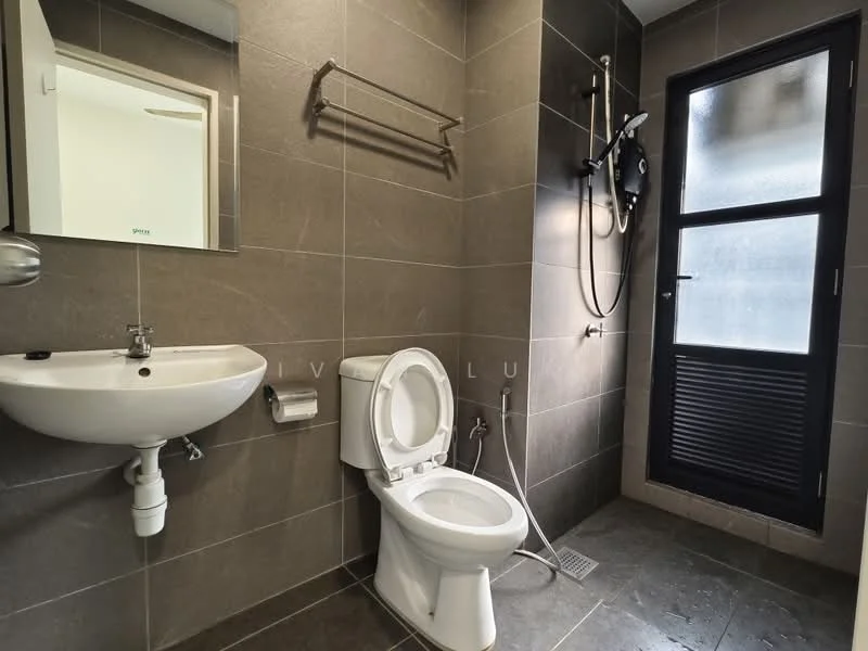 Bathroom features: grey ceramic tile flooring, grey tiled walls, white wall-mounted sink, chrome faucet, one-piece toilet, handheld shower, wall-mounted shower head, mirror above sink, towel rack, window with black louvered shutters; style: modern.