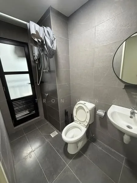 Bathroom features: grey tile flooring, grey wall tiles, white toilet, chrome basin mixer faucet, round mirror, shower with wall-mounted showerhead, glass shower enclosure, white wall-mounted sink, towel rack, window with black frame; style: modern.