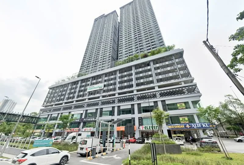 Exterior type: high-rise condominium; features: glass curtain wall, projecting balconies, greenery on balconies, multiple storeys, commercial units at ground level, manicured landscaping, parking area, surrounded by urban environment; style: modern.