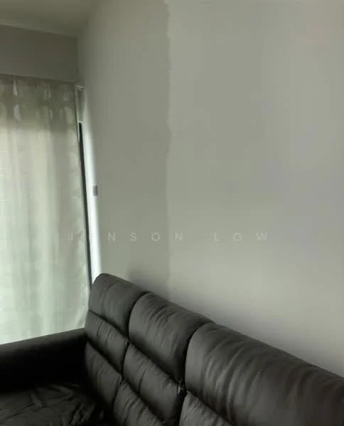 Room features: white painted walls, black leather sofa, sheer curtains.