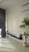 Room features: white painted walls, light-colored flooring, floor-to-ceiling windows, black curtains, indoor plant, minimalist decor, air conditioning unit, shelf or console table; style: modern; view: garden.