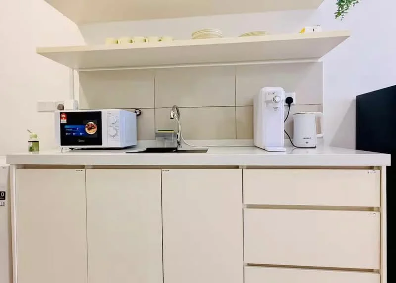 Kitchen features: white cabinetry, white countertop, built-in microwave, stainless-steel sink, chrome faucet, kettle, open shelving, ceramic plates on shelf, neutral tiled backsplash; style: modern.