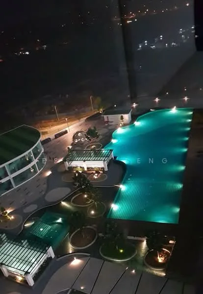 Exterior type: swimming pool deck; features: infinity pool, pool deck with loungers, landscaped garden with trees, water features, ambient lighting, surrounding pathway, modern pavilion structures, nighttime illumination; style: modern.