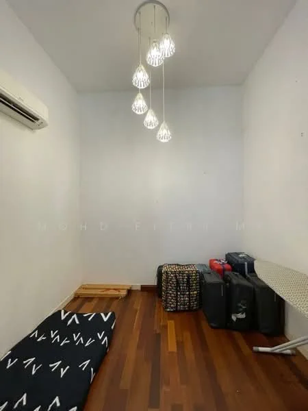 Room features: wooden flooring, white painted walls, 5-blade ceiling light fixture, 1 wall-mounted split AC, ironing board, mattress on the floor, 2 pieces of luggage, decorative blanket.