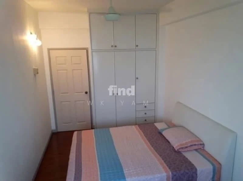 Bedroom features: queen-size bed with upholstered headboard, bedding with patterned design, built-in wardrobe with white finish, wooden flooring, white painted walls, single light fixture on wall, door with panel design, window with no visible treatment; style: modern.