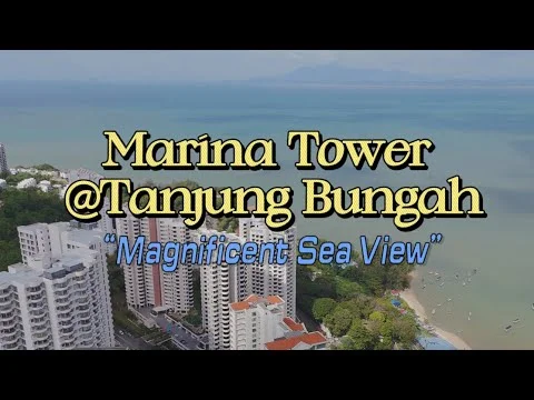 Exterior type: high-rise condominium; features: glass curtain wall, white painted facade, recessed balconies, surrounded by mature greenery, sea view, proximity to beach, multiple storeys, landscaped gardens; style: modern.
