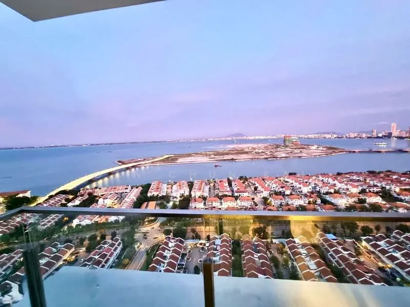 Exterior type: high-rise condominium; features: panoramic view of the sea, city skyline in the background, surrounded by residential houses, balcony with glass railing, evening lighting, waterfront access, landscape view, urban context; style: modern.
