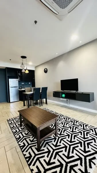 Living features: 3-seater fabric sofa in dark blue, wooden coffee table, area rug with geometric pattern in black and white, wall-mounted TV, TV console in black, recessed downlights, ceiling-mounted air conditioning unit, dining table with 4 upholstered chairs, kitchen area with stainless-steel fridge, open-plan layout, light grey painted walls, wooden flooring in light colour; style: modern.
