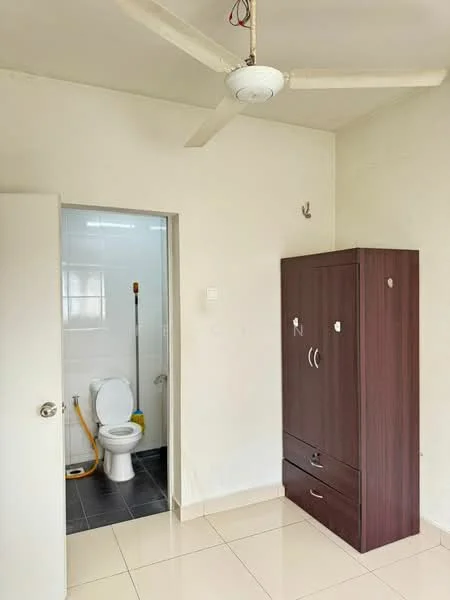 Room features: white painted walls, tile flooring, ceiling fan, brown wooden wardrobe, door leading to bathroom, visible toilet, shower area, grey tiled flooring in bathroom.