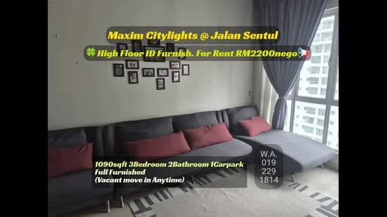 Living features: grey fabric L-shape sectional sofa, red accent cushions, light grey walls, wooden flooring, wall-mounted photo frames, large window with city view, curtains, area rug; style: modern; view: city.