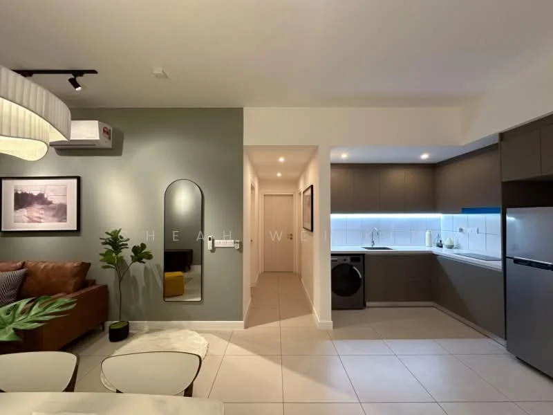 Living features: 3-seater brown leather sofa, coffee table with white top, decorative plant in pot, wall-mounted air conditioning unit, framed artwork on wall, mirror with rounded edges, recessed LED downlights, tile flooring, green accent wall, open layout to kitchen, dining area visible; style: modern. Kitchen features: L-shaped kitchen layout, stainless-steel fridge, built-in oven, ceramic cooktop, white cabinetry, white backsplash, single-bowl stainless-steel sink, chrome pull-down faucet, washer/dryer combo unit, under-cabinet lighting; style: modern. Hallway features: neutral painted walls, tile flooring, doorway leading to bedrooms, recessed lighting; style: modern.