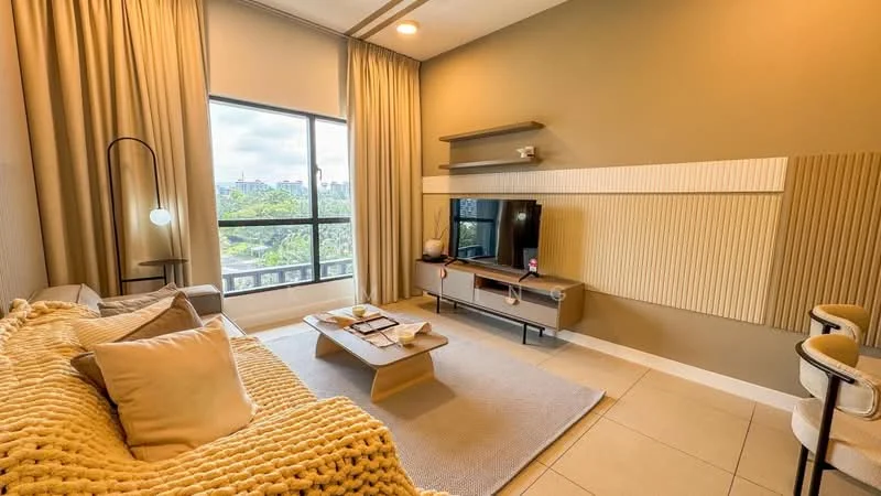 Living features: beige fabric sofa with throw pillows, wood coffee table, TV console with wall-mounted TV, area rug in light grey, floor-to-ceiling window, sheer curtains, decorative wall paneling, recessed lighting, light beige painted walls, light-colored tiled flooring; style: modern; view: city.