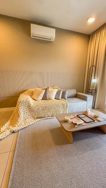 Living features: beige fabric sofa, knitted throw blanket, wooden coffee table, area rug with neutral color, wall-mounted split AC, recessed lighting, textured accent wall, floor-to-ceiling curtains; style: modern.