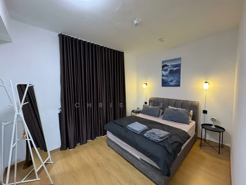 Bedroom features: queen-size bed with grey upholstered headboard, dark bedding with grey and black accents, two bedside lamps with wall-mounted fixtures, floor-to-ceiling dark curtains, light wood flooring, decorative wall art with ocean theme, full-length mirror on stand, wall-mounted power outlets; style: modern.