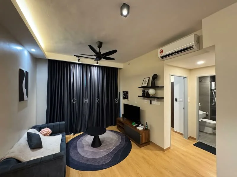 Living features: 3-seater fabric sofa in dark grey, black coffee table, wall-mounted TV, wooden TV console, area rug with circular pattern, 5-blade ceiling fan with light, recessed downlights, blackout curtains, laminate flooring, air conditioning unit, decorative wall art; style: modern. Room features: doorway leading to bathroom, light-colored walls, wooden door.