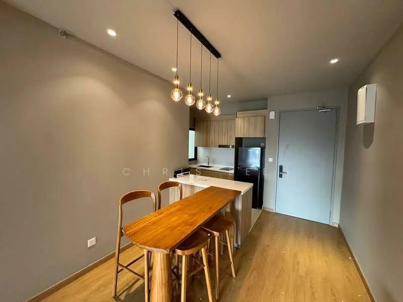 Kitchen features: wooden bar table with high stools, pendant lighting with multiple bulbs, white countertop, stainless-steel fridge, wood cabinetry, grey painted walls, laminate flooring, recessed ceiling lights, open layout, kitchen island; style: modern.