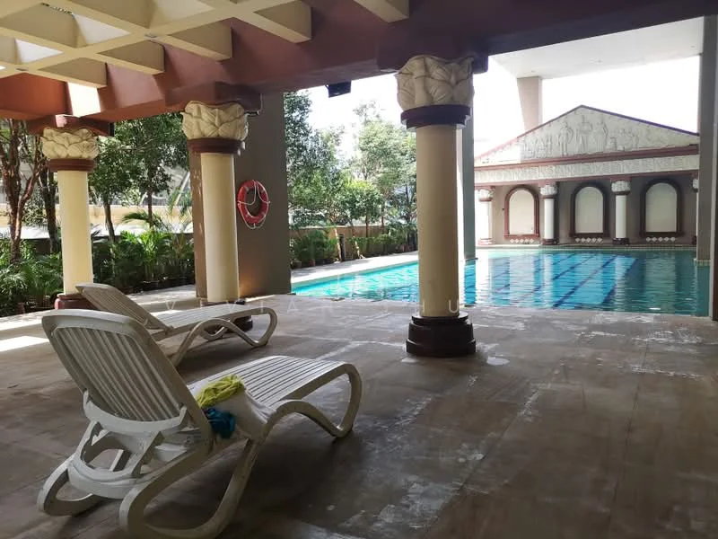 Exterior type: swimming pool deck; features: swimming pool with lap lanes, pool deck with loungers, decorative columns, landscaped greenery, poolside safety ring, covered area with ceiling, ornate wall design, tile flooring, sun loungers in white, potted plants; style: modern.