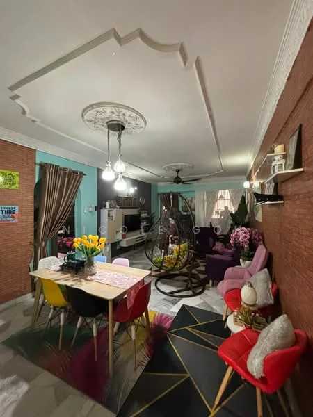 Living features: tray ceiling with decorative moulding, ceiling fan with light, hanging rattan chair, wall-mounted TV, wooden accent wall, green accent wall, large window with sheer curtains, area rug with geometric pattern, sofa with red upholstery, dining table with floral tablecloth, colorful dining chairs, decorative plants, wall shelves with decor items, artificial flowers in vases; style: modern.